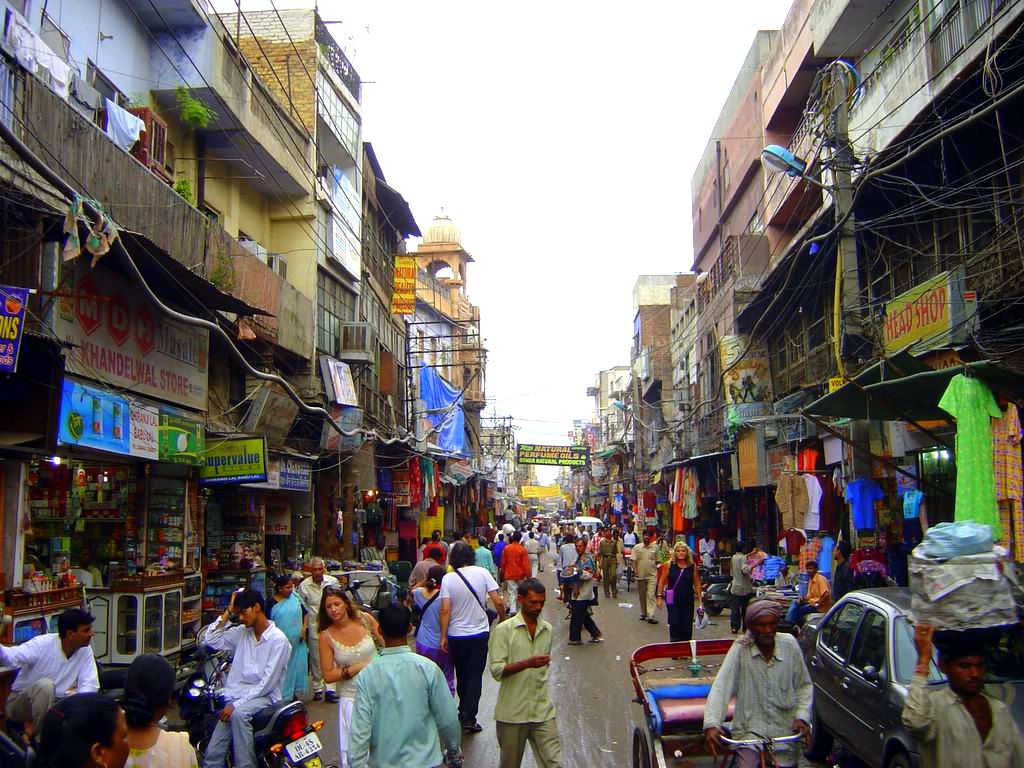 Shops and pedestrians in a Delhi market street