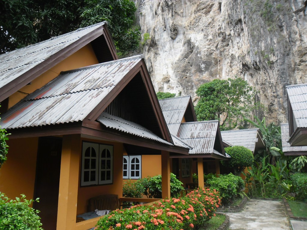 Colourful cottage beside a rocky hillside