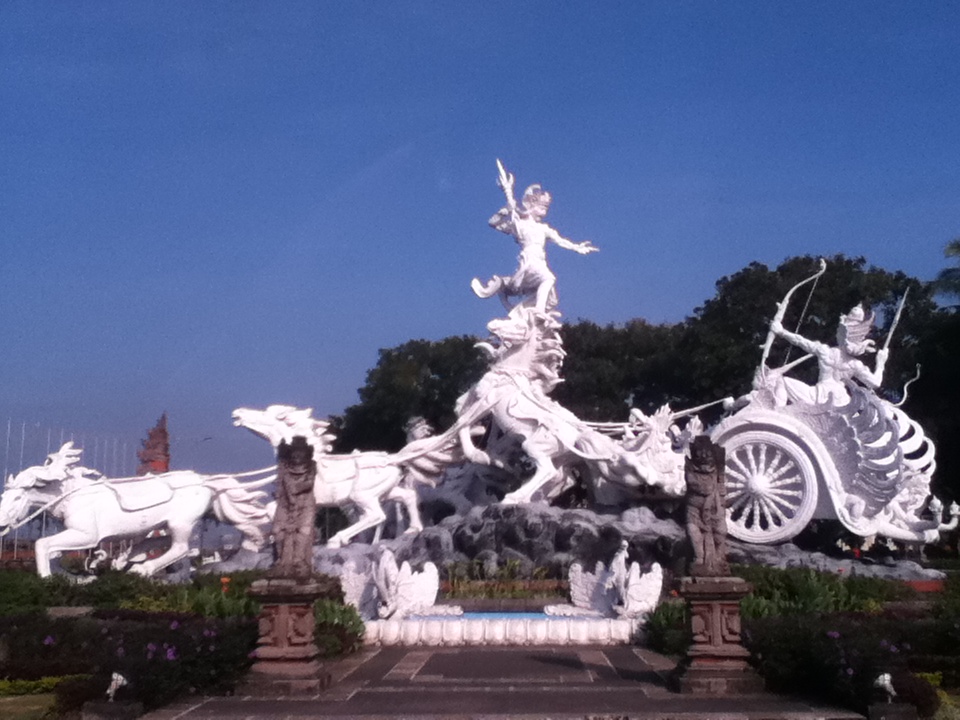 White sculptural figures against a blue sky